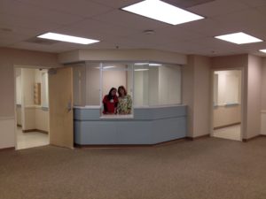 two clinic team members standing in empty lobby of new CCHC location