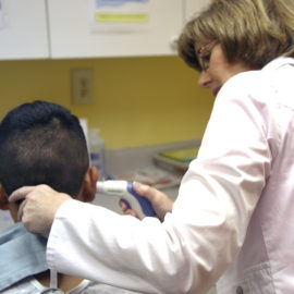 doctor looks into a child's ear