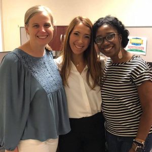 CCHC intern smiling with two team members