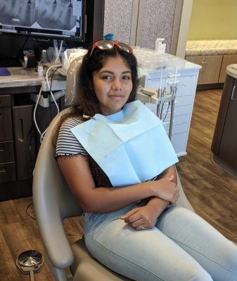young patient sitting in dental chair