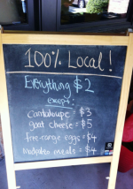 chalkboard sign with prices at CCHC community garden