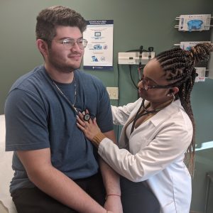 doctor listening to patient's heartbeat